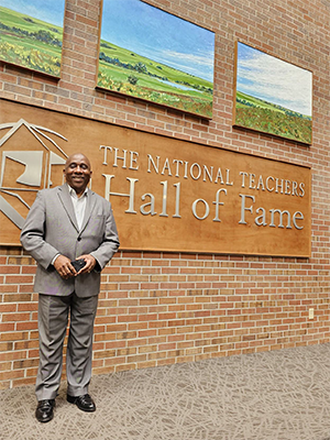 Man stands in front of sign that says National Teachers Hall of Fame