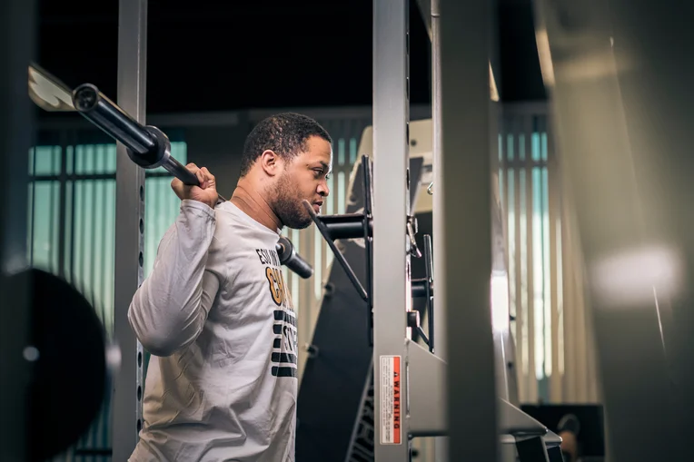 Student lifting weights at Student Recreation Center