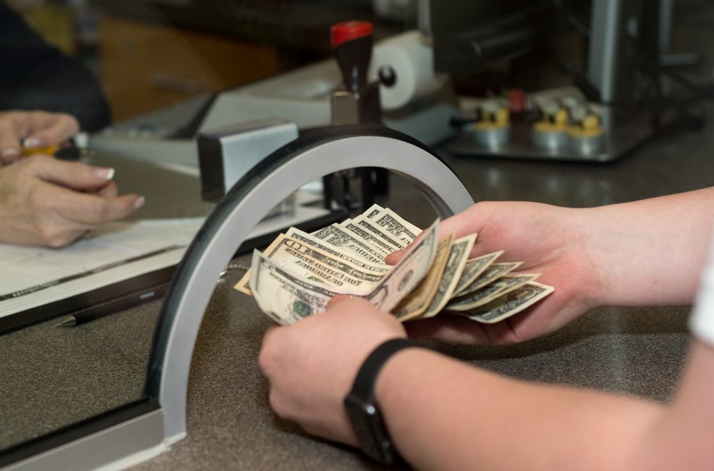 Money being handed through cashier window