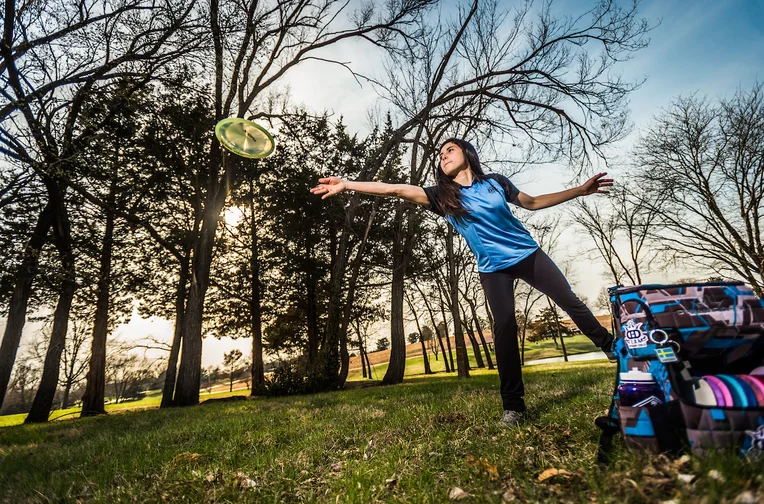 Student playing disc golf