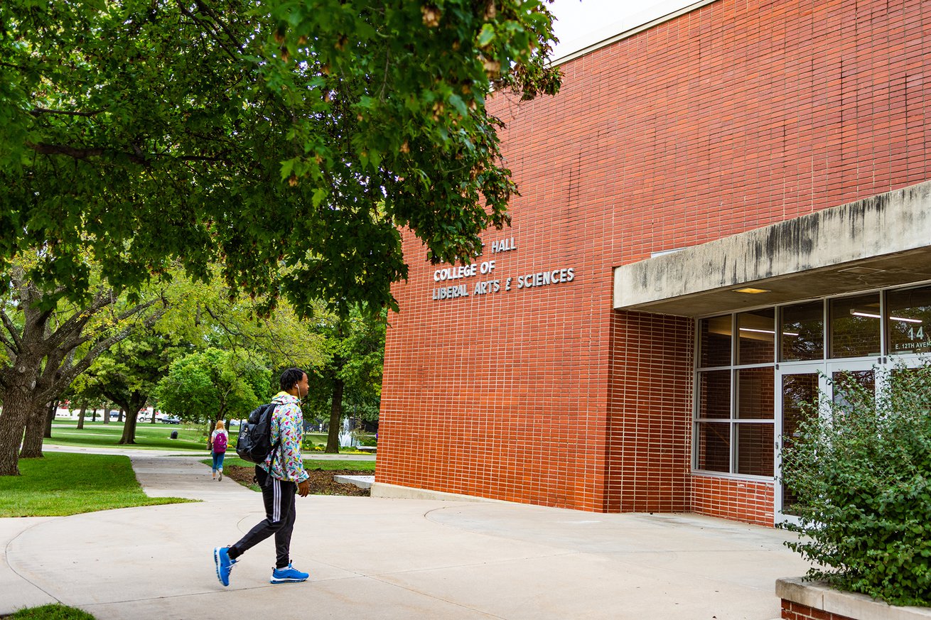 Student walking into campus building