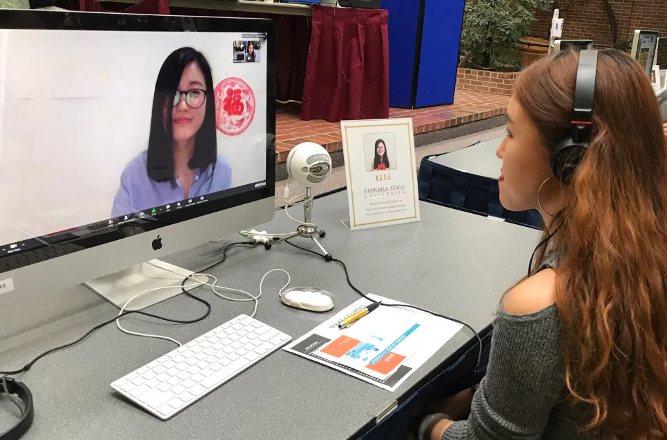 Emporia State student listening to online presentation