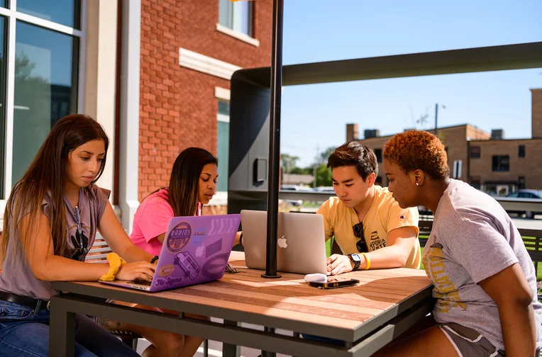 Students studying in front of Schallenkamp Residence Hall