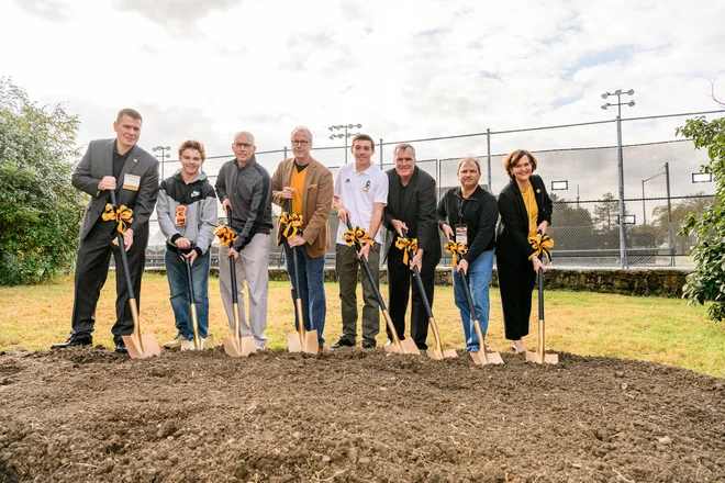Faculty and staff holding golden shovels at Kossover Tennis Complex Groundbreaking