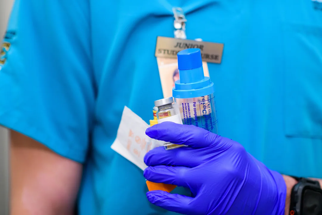 Nursing student holding vial