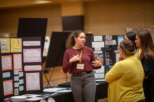 Student discussing poster presentation at Emporia State University's Research & Creativity Day