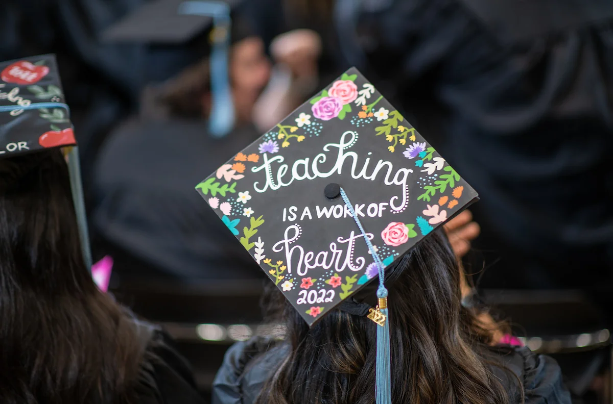 Graduation hat with the words "Teaching is a work of the heart"