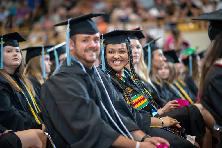 Students smiling at commencement