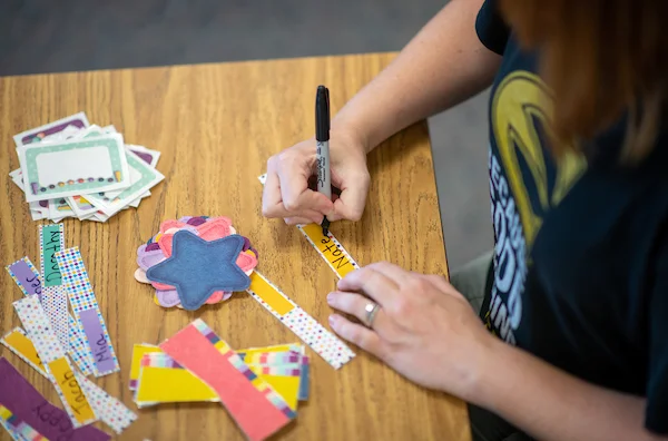 Elementary teacher writing on signs