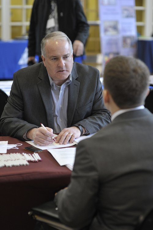 A recruiter for Lawrence, Kansas, Public Schools interviews an education major on the Emporia State campus during a teacher career fair in March 2015. 