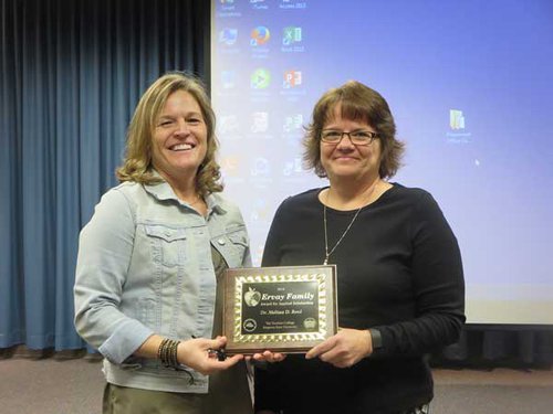 Dr. Joan Brewer, associate dean of Emporia State’s Teachers College, left, presents Dr. Melissa Reed, associate professor in the elementary education/early childhood/special education department, with the Ervay Family Award for Applied Scholarship.