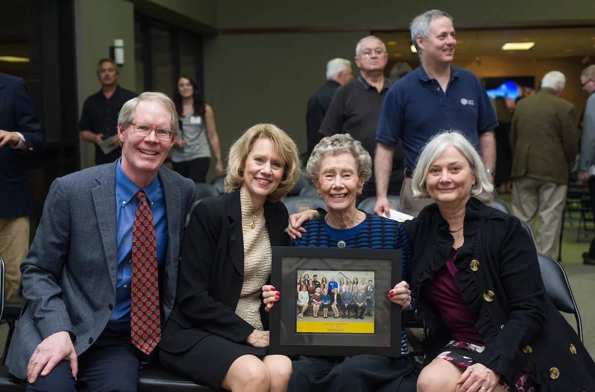 Emporia State alums holding framed photo during event