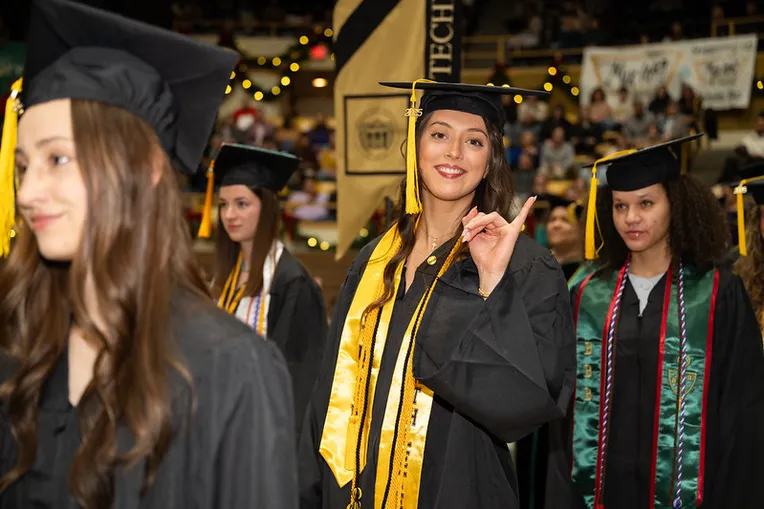 Students smiling at commencement