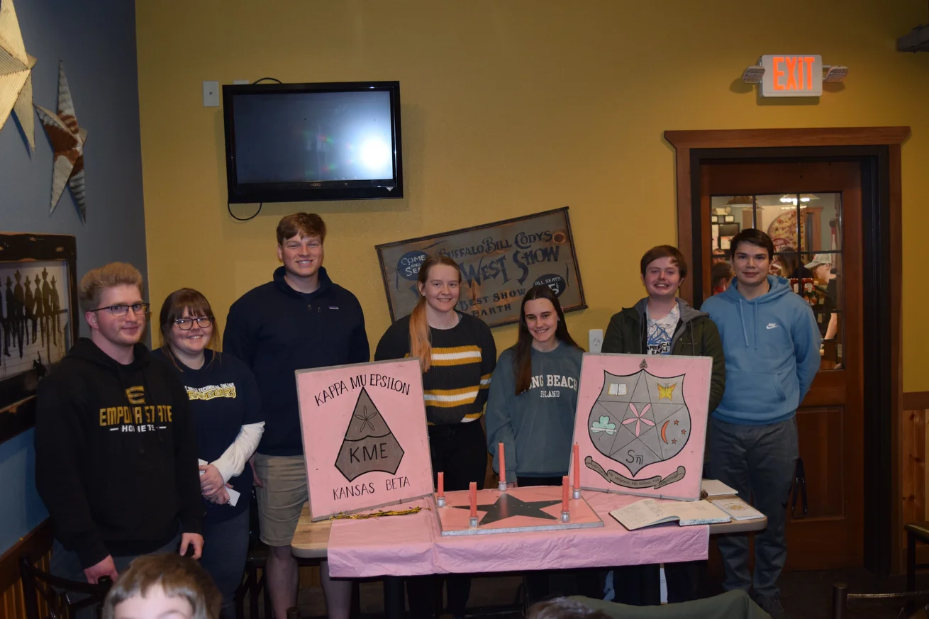 Seven students showing 2 pink canvases