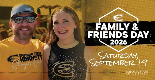 A man wearing a Hornets shirt and a cheerleader smiling at the Emporia State University Family and Friends Day.