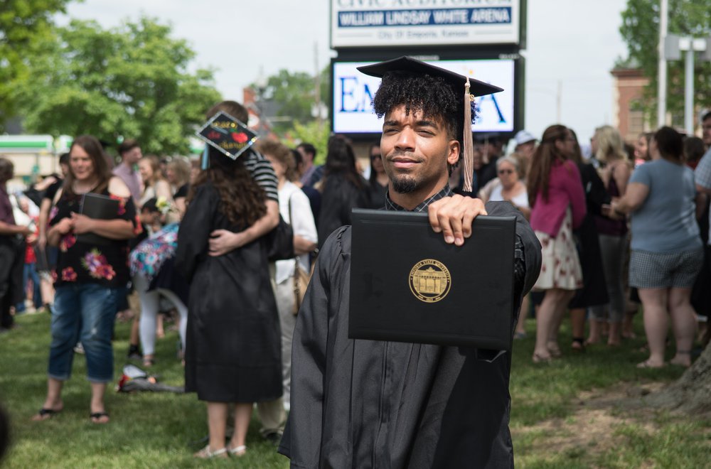 Emporia State student holding diploma