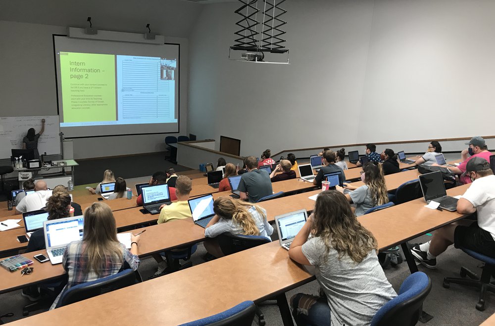 Students listening to instructor in lecture hall