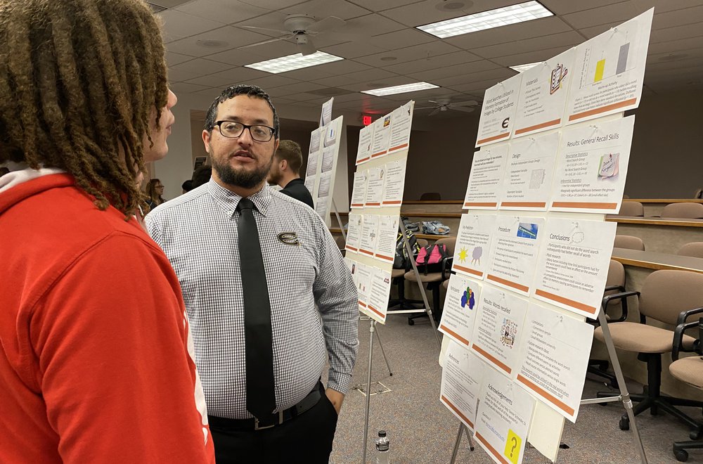 Emporia State Psychology students discussing poster presentation