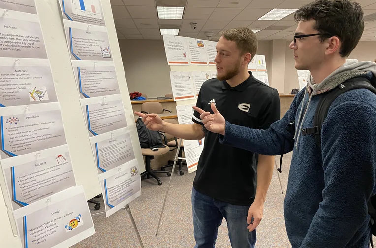 Emporia State Psychology students discussing poster presentation