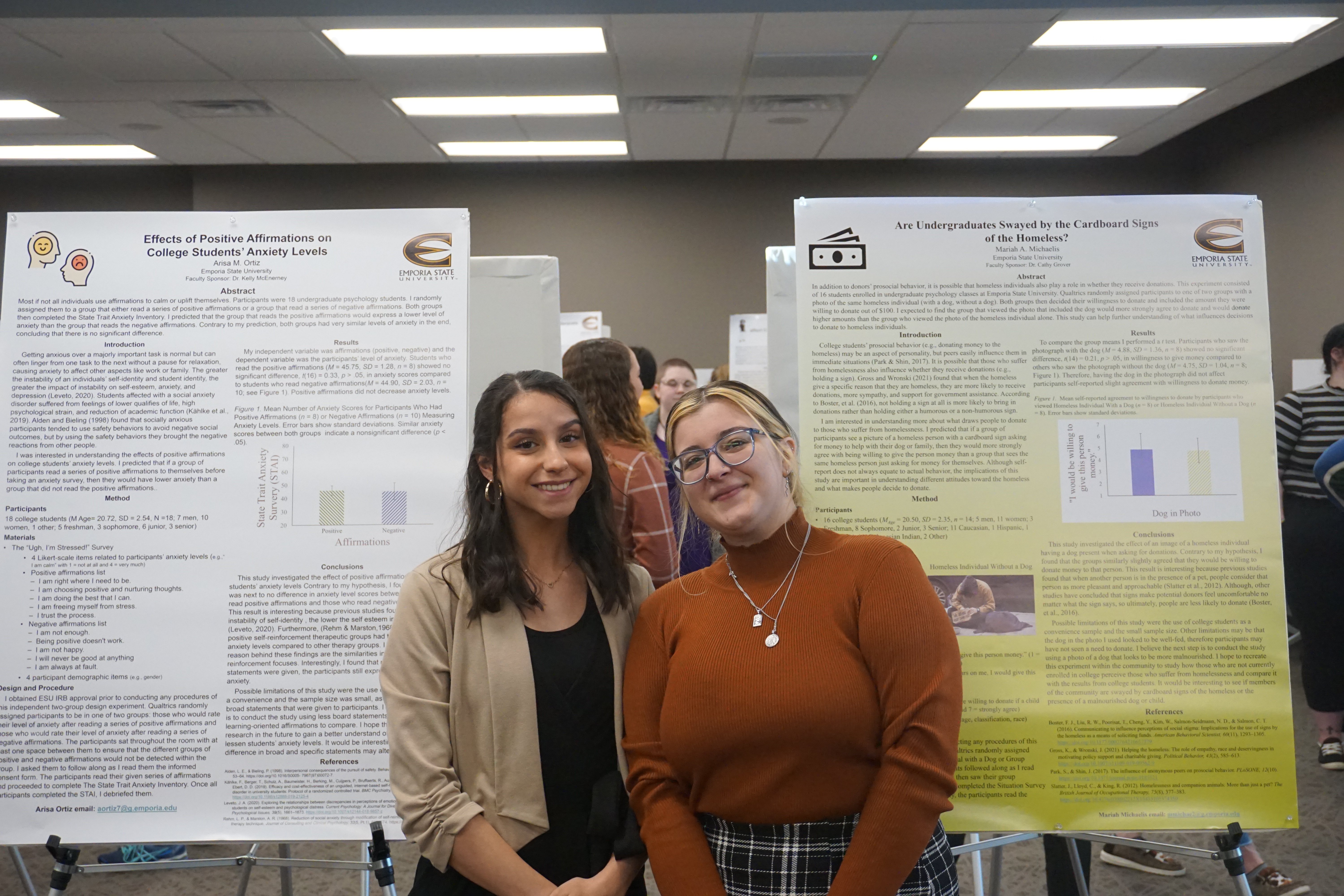 Emporia State University students posing next to poster presentations