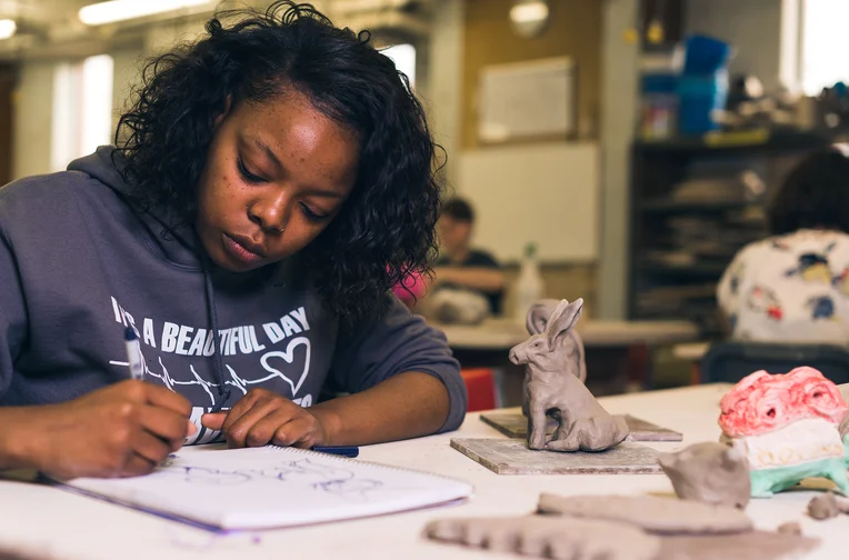 Emporia State Department of Art student working with clay