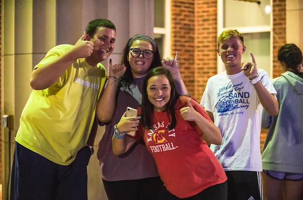 Group of students giving stingers up gesture