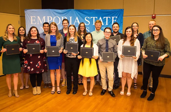 Students posing with awards