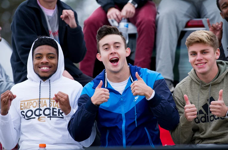 Group of Emporia State students cheering at football game