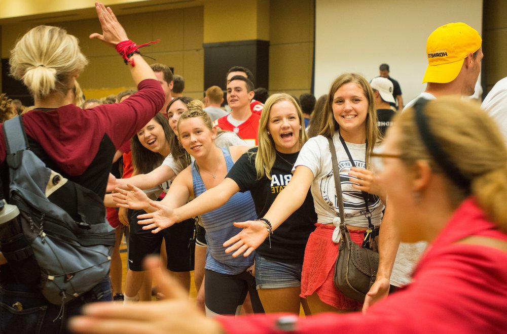 Students hands out.jpg