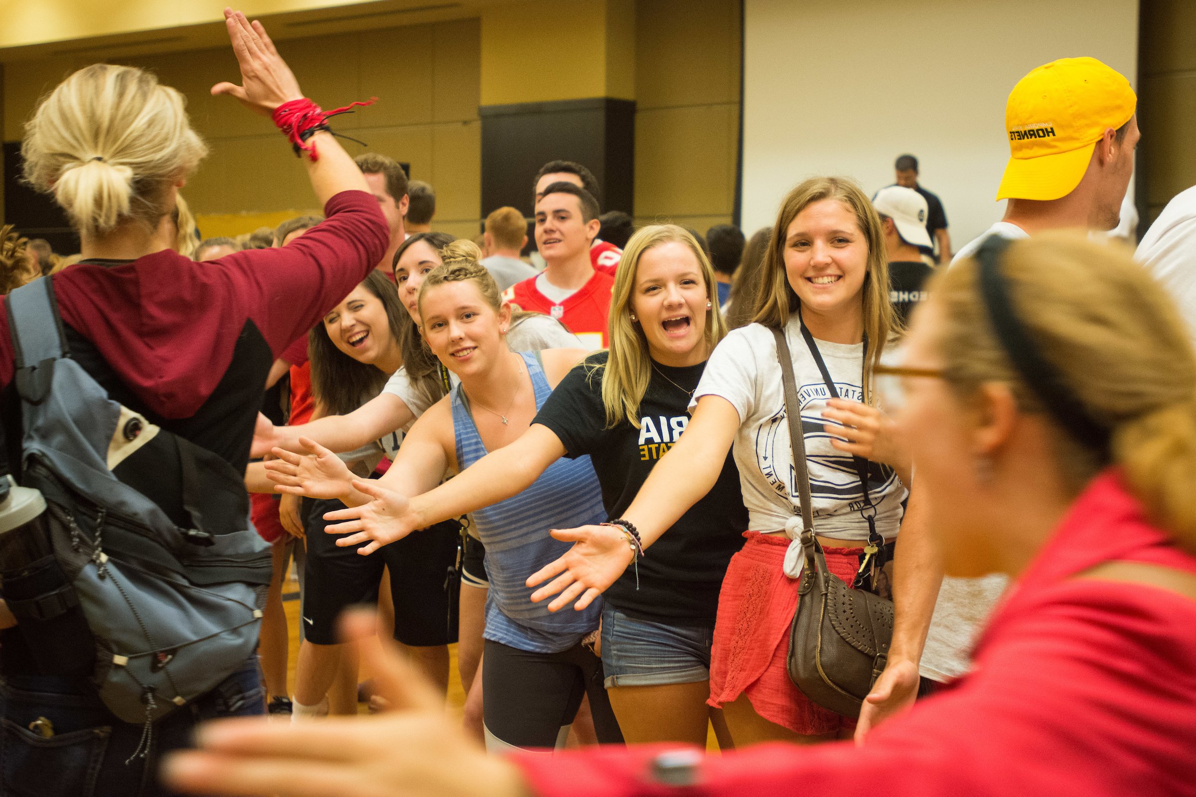 Emporia State students high-fiving each other