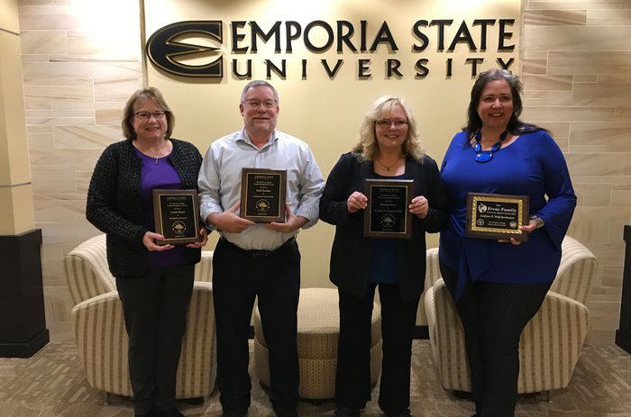 Faculty posing with awards from The Teachers College