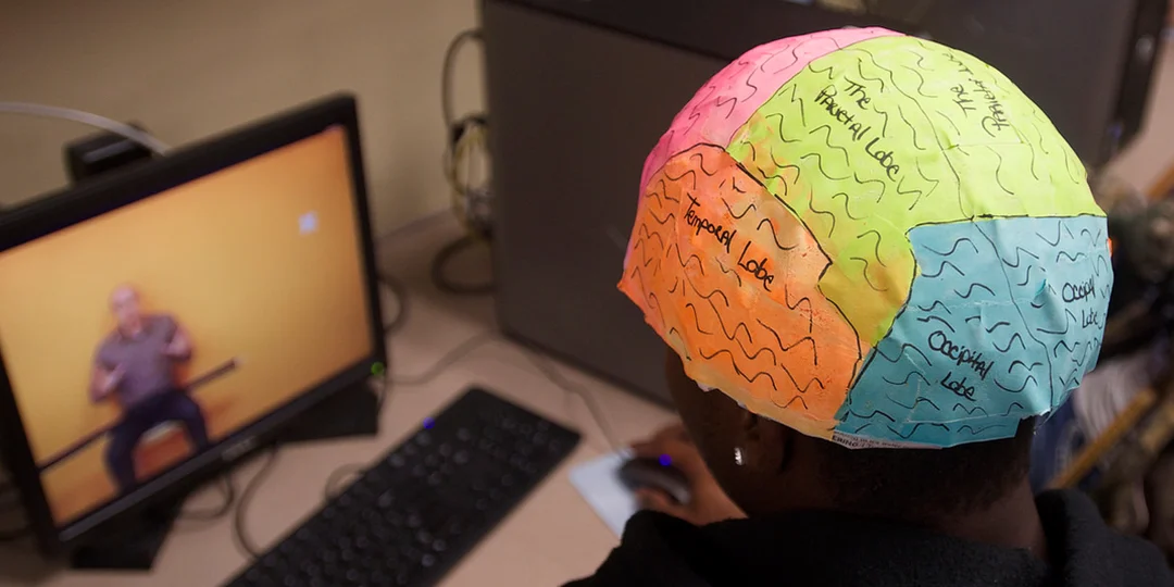 student wearing brain diagram helmet