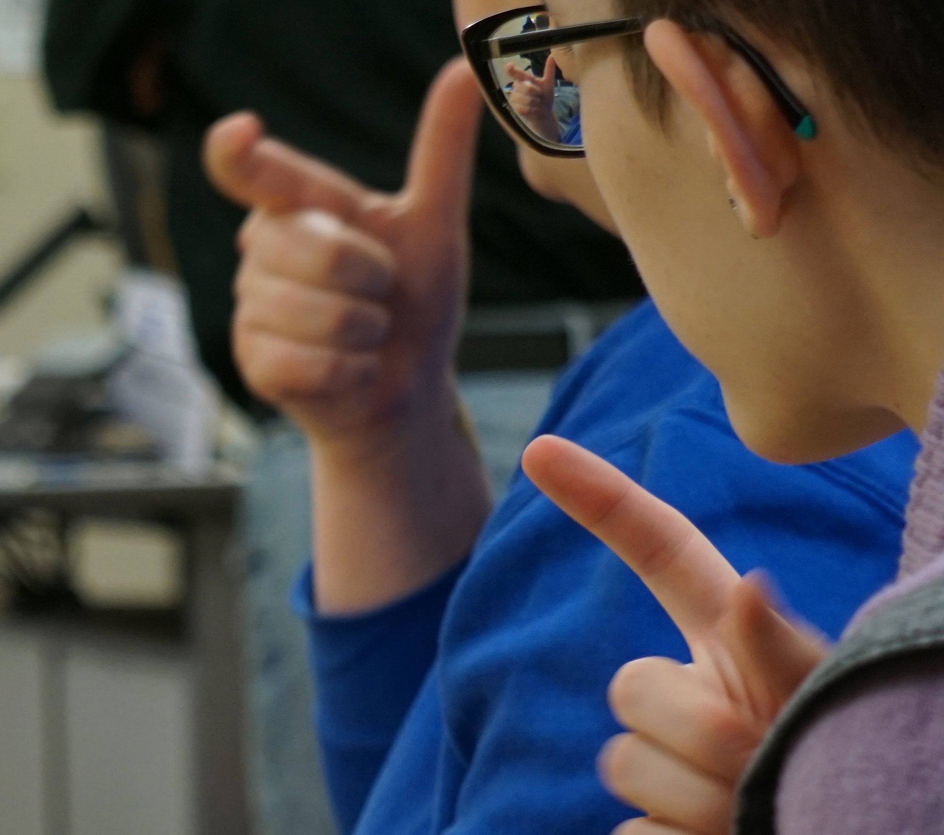 Person signing in ASL class