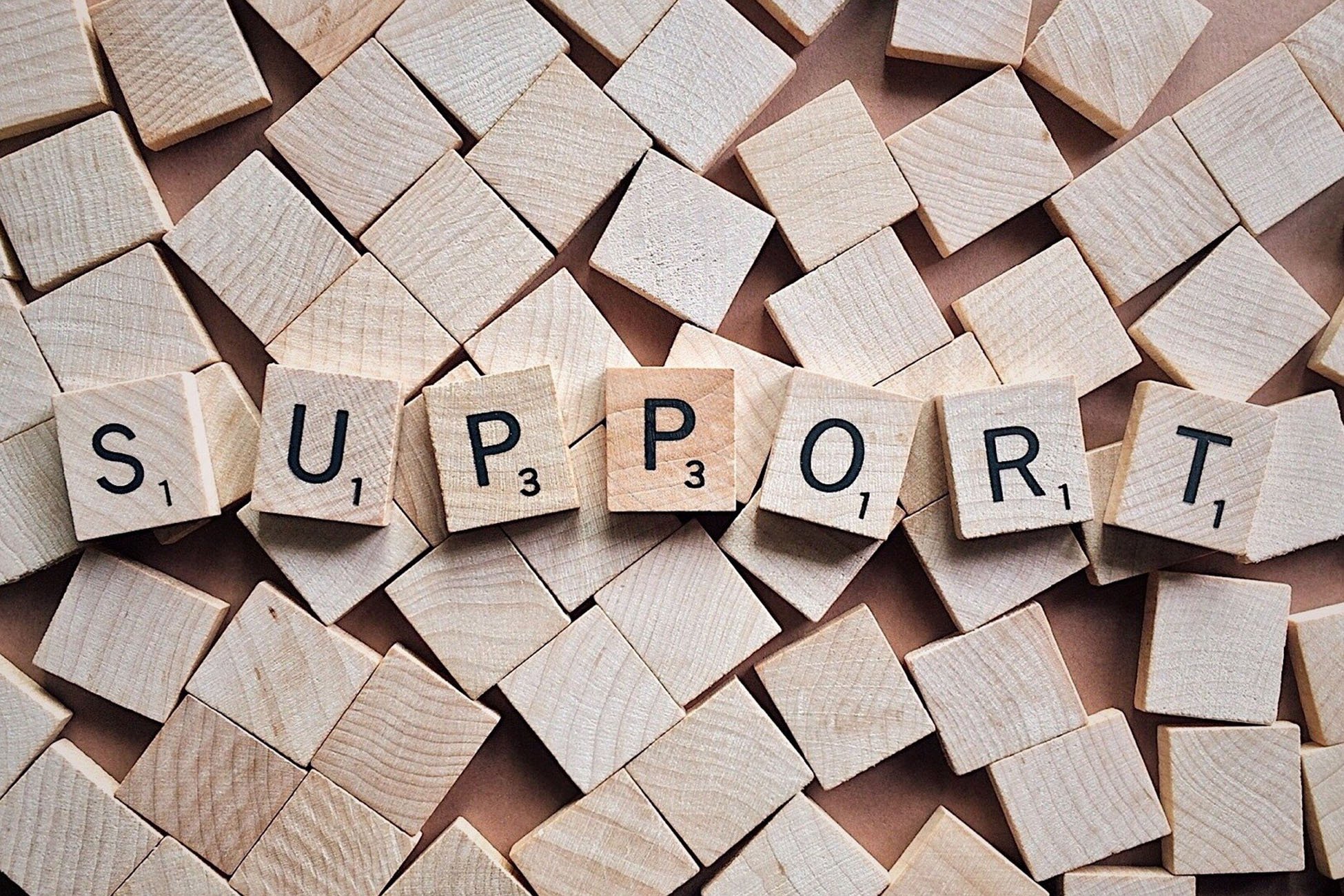 "Support" spelled out on Scrabble tiles