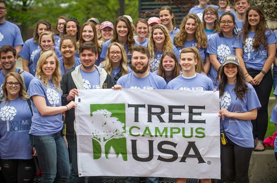 Group of students holding Tree Campus USA sign