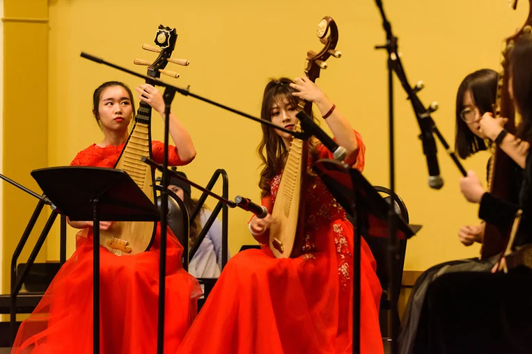 Four Emporia State students play stringed instruments