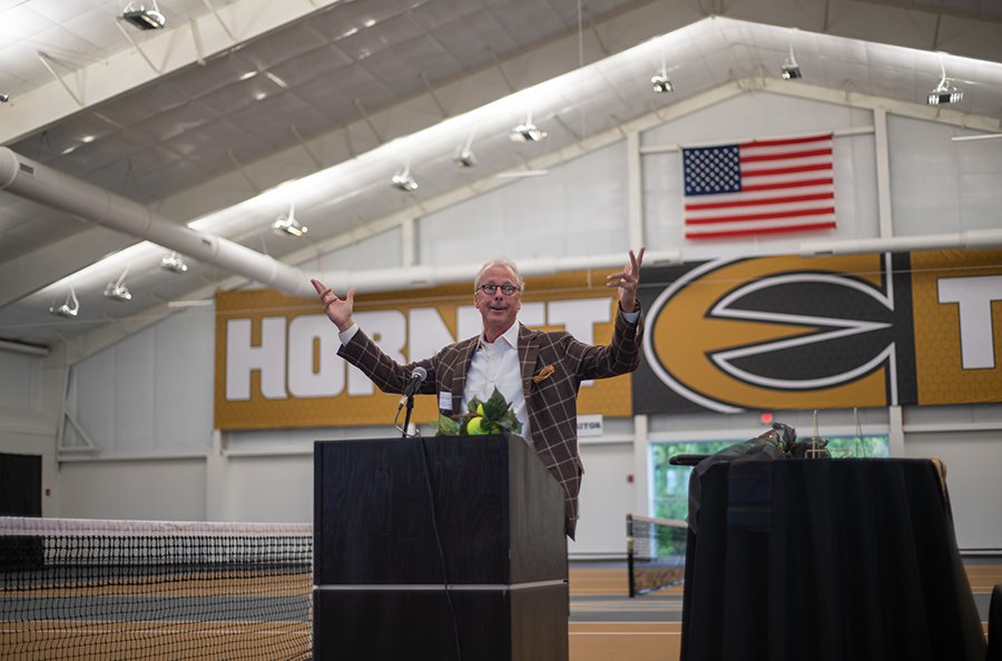 Ken Hush, Emporia State interim president, speaks at podium during Kossover Tennis Complex ribbon cutting