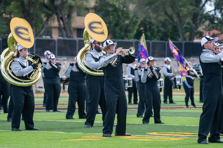 Members of marching band on football field