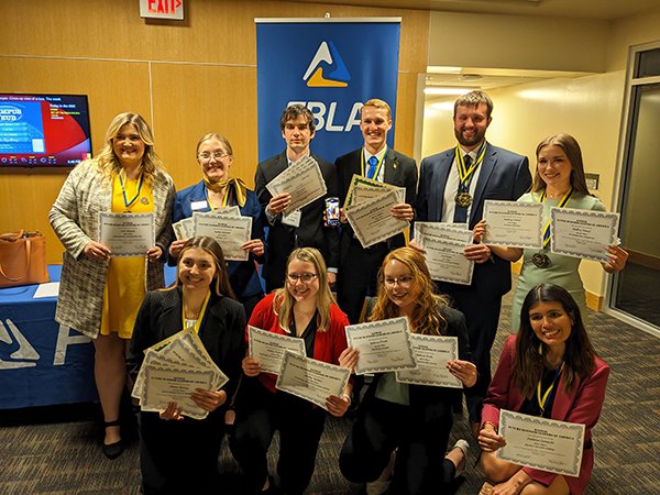 Eleven students pose with their certificates from a state competition.