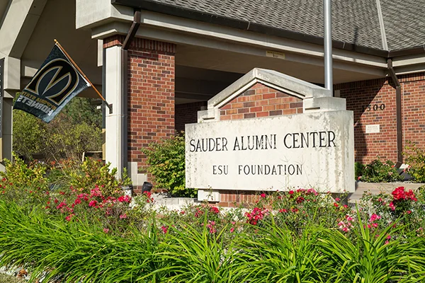 Exterior of red brick building with sign in front: Sauder Alumni Center | ESU Foundation